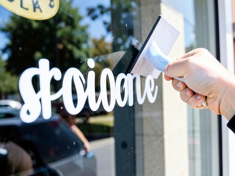 White vinyl lettering decal applied to a storefront window